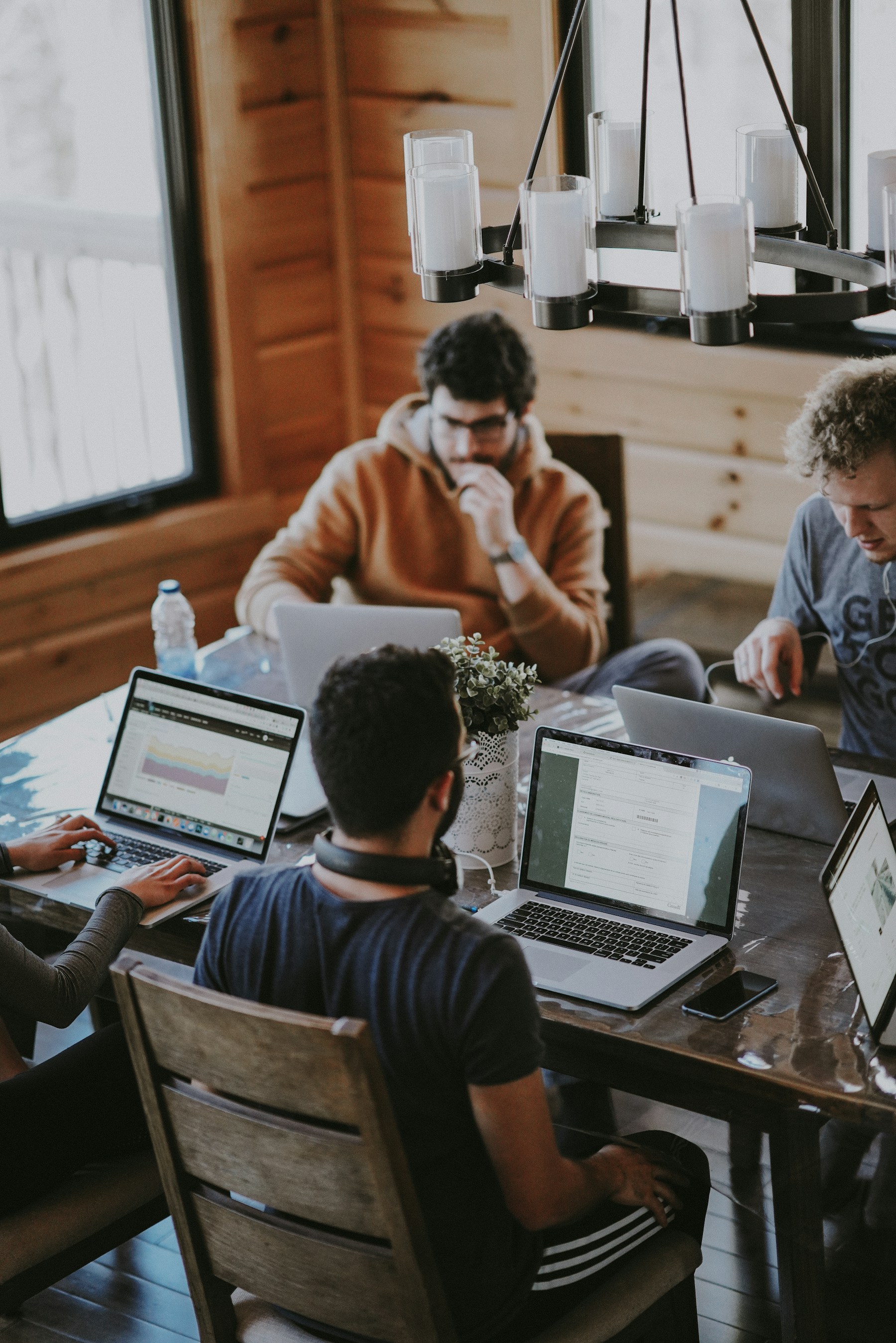 A product team collaborating around laptops